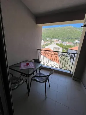 a balcony with a table and chairs and a view at Cozy Montenegro Experience, 50m from the beach in Petrovac na Moru