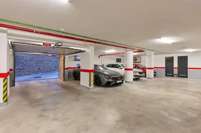 a garage with two cars parked in it at Hotel Diplomat by Aycon in Budva