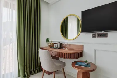a room with a desk with a chair and a mirror at Hotel Diplomat by Aycon in Budva