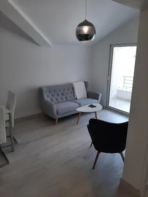 a living room with a couch and a table at Luxury flat with amazing view INES in Kotor