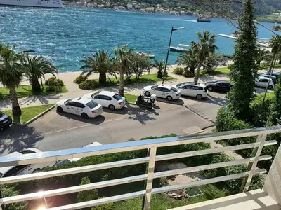 a group of cars parked in a parking lot near the water at Luxury flat with amazing view INES in Kotor