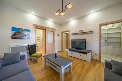 a living room with a couch and a tv at Apartments Milunović in Kotor
