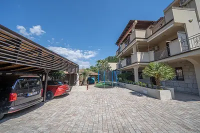 a car parked in a parking lot next to a building at Apartments Milunović in Kotor