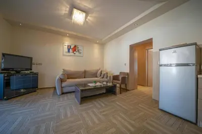 a living room with a couch and a refrigerator at Apartments Milunović in Kotor
