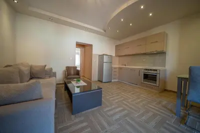 a living room with a couch and a kitchen at Apartments Milunović in Kotor