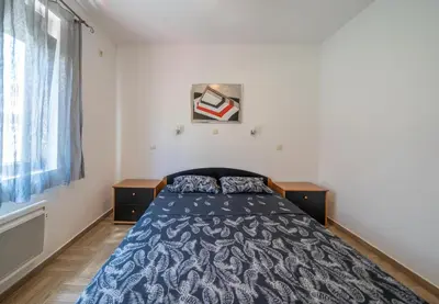 a bedroom with a bed and a window at Apartments Milunović in Kotor