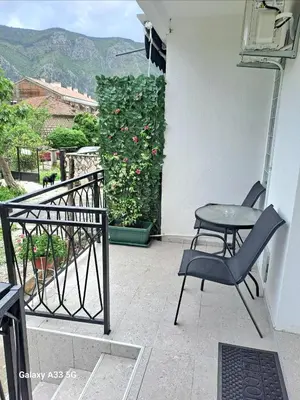 a chair and a table on a balcony at Apartment Marina 2 in Kotor
