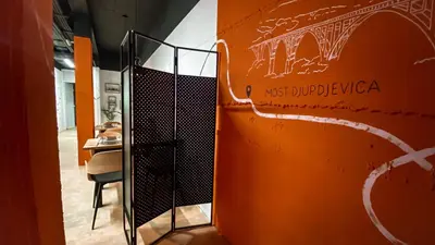 an orange wall with a door in a room at Magic Point in Kruče