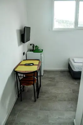 a small room with a table and a bed at Magic Point in Kruče