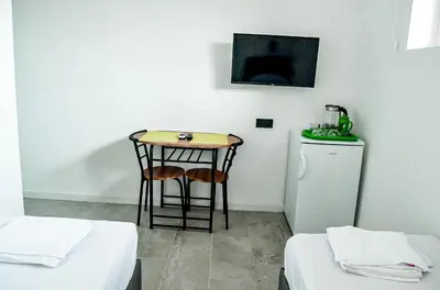 a small table in a room with two beds at Magic Point in Kruče