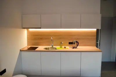 a kitchen with a sink and white cabinets at Magic Point in Kruče