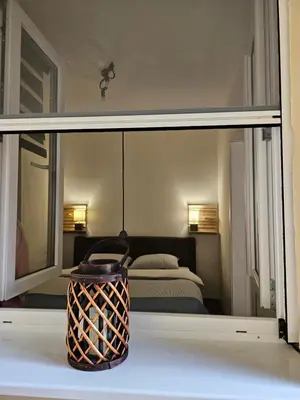 a view of a bedroom with a bed through a window at Apartman Pontica in Kotor