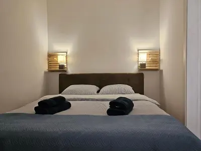 a bedroom with a bed with two pillows on it at Apartman Pontica in Kotor
