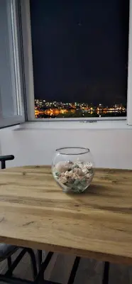 a bowl sitting on a table in front of a window at Apartman Pontica in Kotor