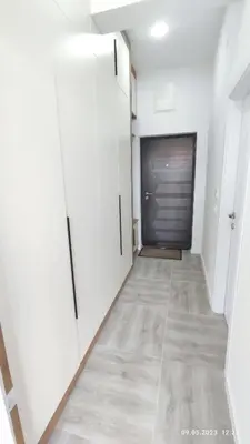 a hallway with white walls and a garage door at Apartments LORA Susanj in Bar