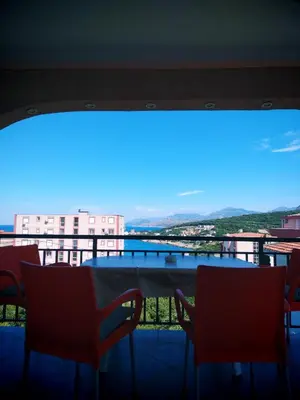 a view of a balcony with a table and chairs at Apartmani LJUBICA in Utjeha