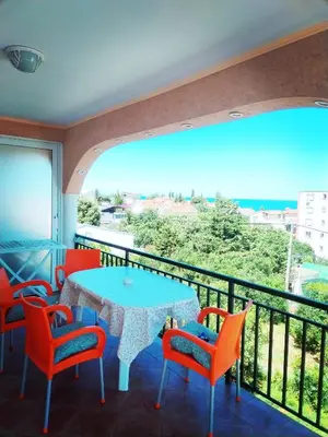 a balcony with a table and chairs and a view at Apartmani LJUBICA in Utjeha