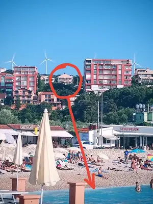 a red object in the water at a beach at Apartmani LJUBICA in Utjeha