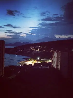 a night view of a city and a body of water at Apartmani LJUBICA in Utjeha