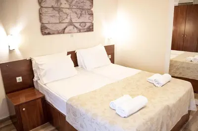two beds in a small room with towels on them at Mali Hotel Porat in Budva