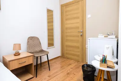 a small room with a chair and a refrigerator at Apartmani F&M in Kotor