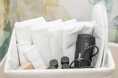 a basket filled with office items and towels at Apartmani F&M in Kotor