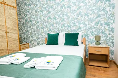 a bedroom with a bed with two towels on it at Apartmani F&M in Kotor