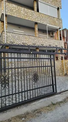 a black iron gate in front of a building at Apartmani Sabotic in Sutomore