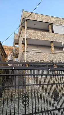 an iron fence in front of a building at Apartmani Sabotic in Sutomore