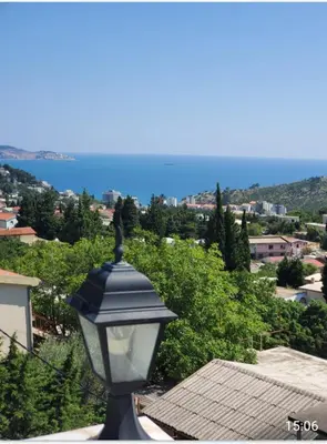 a street light with a view of the ocean at Apartmani Sabotic in Sutomore
