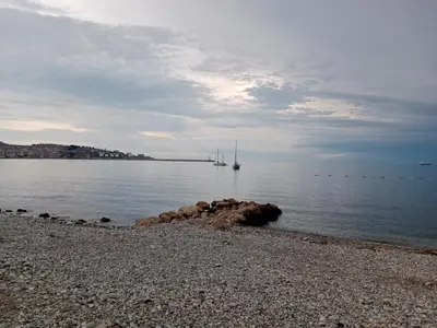 a beach with a sail boat in the water at Studio apartmani Dream Iv in Bar, Susanj