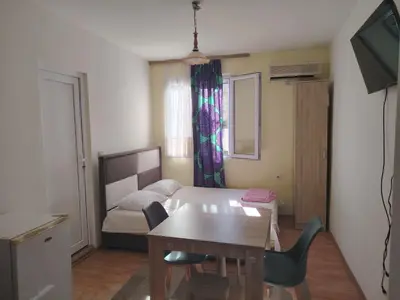 a small room with a table and a bed at Studio apartmani Dream Iv in Bar, Susanj