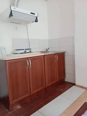 a kitchen with wooden cabinets and a sink at Studio apartmani Dream Iv in Bar, Susanj