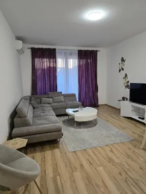 a living room with a couch and a table at Flat Rafailovic One minute to Beach in Budva