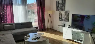 a living room with a couch and a flat screen tv at Flat Rafailovic One minute to Beach in Budva
