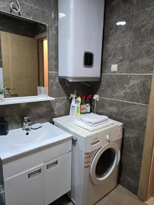 a bathroom with a washing machine and a sink at Flat Rafailovic One minute to Beach in Budva