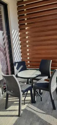 a patio with chairs and a table and chairs at Flat Rafailovic One minute to Beach in Budva