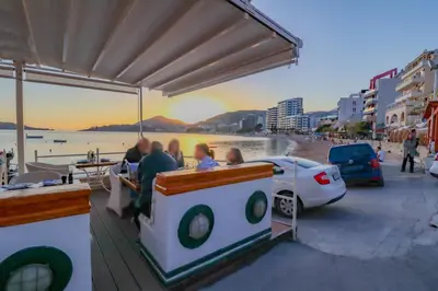 a group of people riding on a boat on the beach at Flat Rafailovic One minute to Beach in Budva