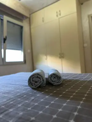 two rolls of towels sitting on top of a bed at Lux apartment Rafailovići in Budva