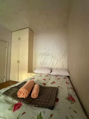 a bedroom with a bed with towels on it at Lux apartment Rafailovići in Budva