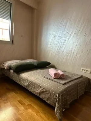 a bedroom with a bed with two towels on it at Lux apartment Rafailovići in Budva