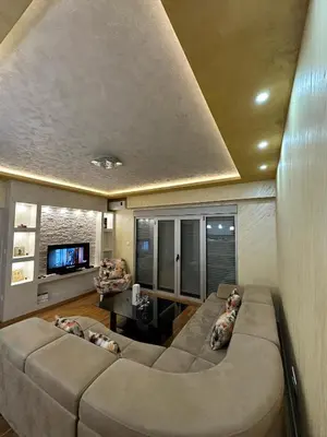 a living room with a large couch and a tv at Lux apartment Rafailovići in Budva