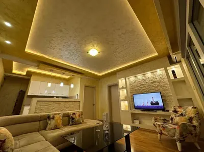 a living room with a couch and a flat screen tv at Lux apartment Rafailovići in Budva