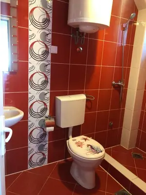 a bathroom with a toilet and a sink at Apartmani Vedrana in Sutomore