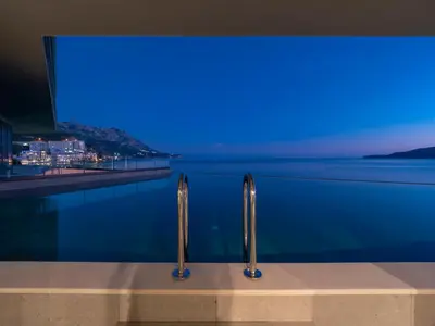 a swimming pool with a view of the water at Sea Star Budva in Budva
