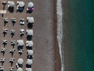 an overhead view of a beach with chairs and the ocean at Sea Star Budva in Budva