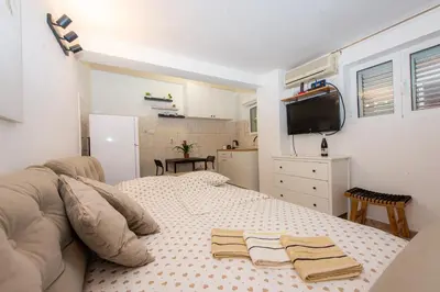 a bedroom with a bed with two towels on it at Studio Apartment Silva in Kotor