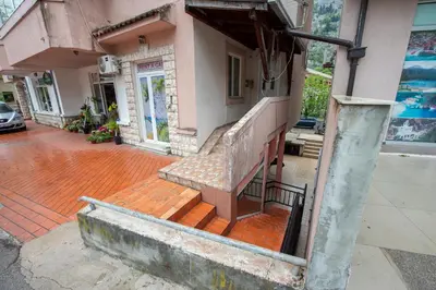 a building with a bench on the outside of it at Studio Apartment Silva in Kotor