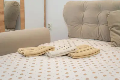 two towels sitting on top of a bed at Studio Apartment Silva in Kotor