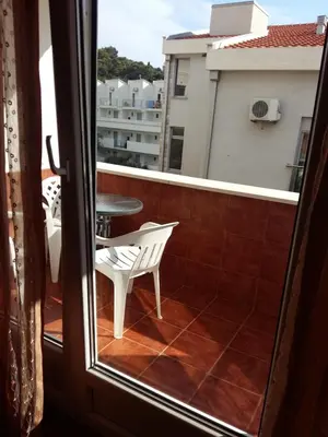 a view of a balcony with a table and a chair at Lazar Apartments in Petrovac na Moru